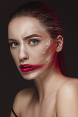 Image showing Fashion Model Girl with colored face painted. Beauty fashion art portrait of beautiful woman with colorful abstract makeup.