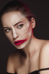 Image showing Fashion Model Girl with colored face painted. Beauty fashion art portrait of beautiful woman with colorful abstract makeup.