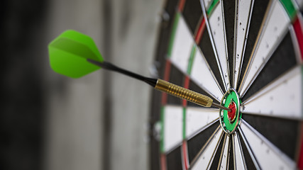 Image showing a typical darts game with dart in the bullseye