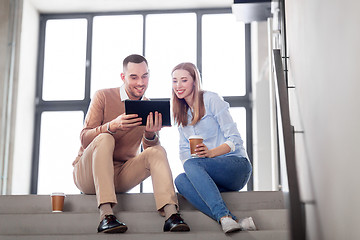 Image showing man and woman with tablet pc and coffee on stairs