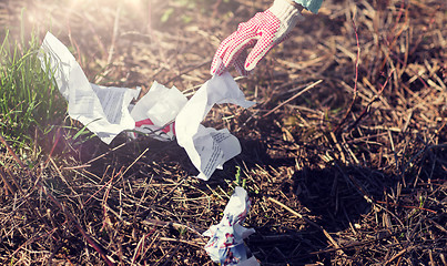 Image showing volunteer hand cleaning area from garbage