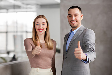 Image showing businesswoman and businessman showing thumbs up
