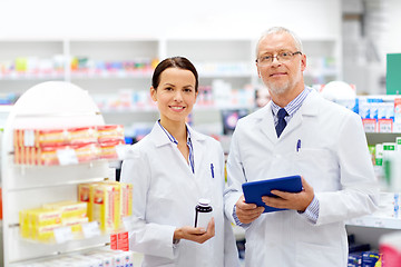 Image showing apothecaries with tablet pc and drug at pharmacy