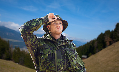 Image showing young soldier in military uniform outdoors
