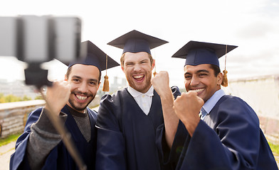 Image showing happy male students or graduates taking selfie