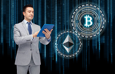 Image showing businessman with tablet pc and cryptocurrency