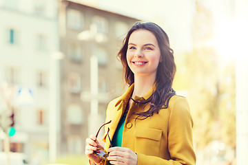Image showing smiling young woman in city