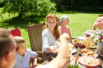 Image showing happy family having dinner or summer garden party