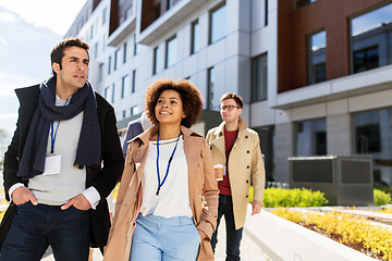 Image showing people with coffee and conference badges in city