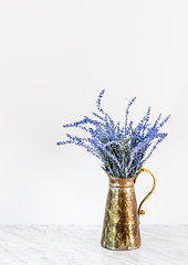 Image showing Blue lavender in antique metal jar