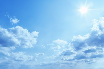 Image showing bright blue sky with sun and clouds background