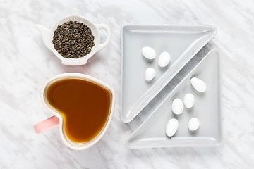 Image showing Heart shaped mug, green tea and white chocolate