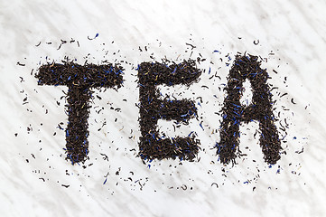 Image showing The word TEA written with black Earl Gray leaves