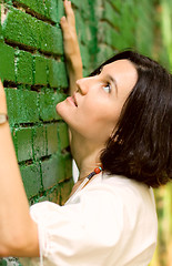 Image showing Woman and green wall