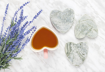 Image showing Cup of flavored tea and blue lavender