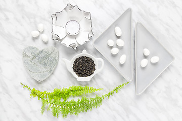 Image showing Green tea leaves, white chocolate and home decor styling