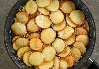 Image showing frying potatoes in pan with oil