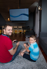 Image showing Happy family playing a video game