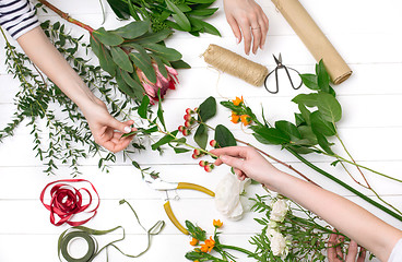 Image showing Female florist making beautiful bouquet at flower shop