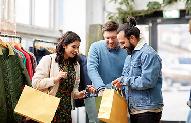 Image showing friends shopping bags at vintage clothing store