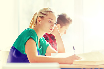 Image showing group of students with books writing school test