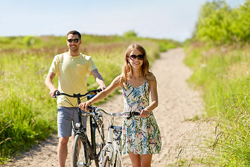 Image showing happy couple with bicycles on country road