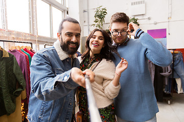 Image showing friends taking selfie at vintage clothing store