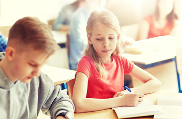 Image showing group of students with books writing school test