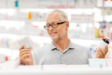 Image showing senior male customer choosing drugs at pharmacy