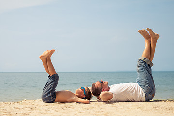 Image showing Father and son playing on the beach at the day time.