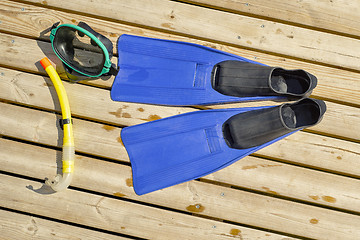 Image showing Diving mask, fins, snorkel on wooden pier