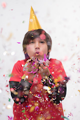 Image showing kid blowing confetti