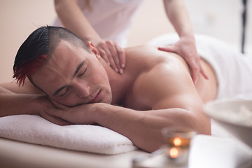 Image showing young man having a back massage