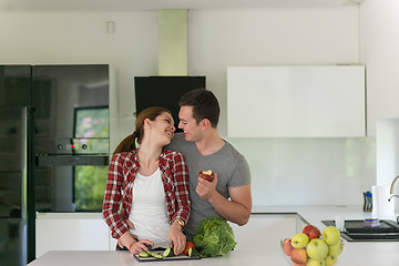 Image showing Young handsome couple in the kitchen