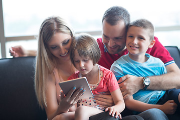 Image showing happy young couple spending time with kids