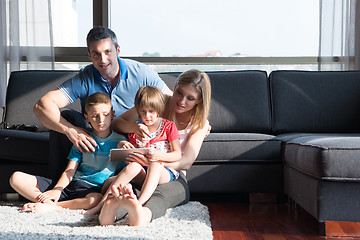 Image showing happy young couple spending time with kids