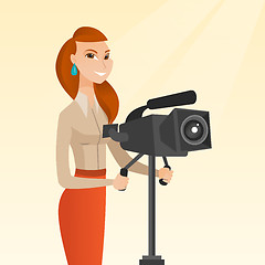 Image showing Cameraman with movie camera on tripod.