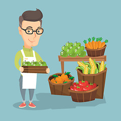 Image showing Supermarket worker with a box full of apples.