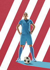 Image showing Professional football soccer player with ball on colorful background