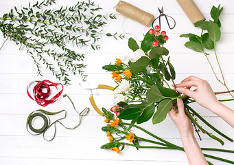 Image showing Female florist making beautiful bouquet at flower shop