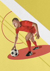 Image showing Professional football soccer player with ball on colorful background