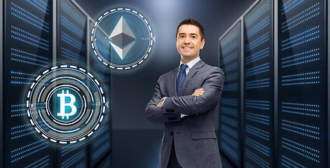 Image showing businessman with cryptocurrency holograms