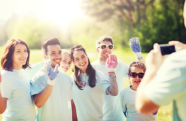 Image showing group of volunteers taking picture by smartphone