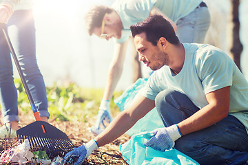 Image showing volunteers with garbage bags cleaning park area