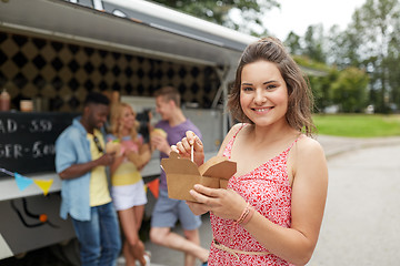 Image showing happy woman with wok and friends at food truck