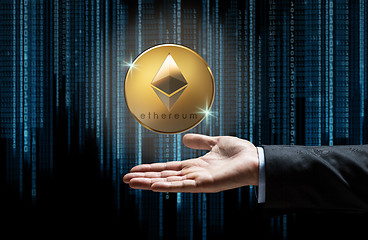 Image showing businessman hand with etherum over binary code