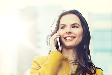 Image showing smiling young woman or girl calling on smartphone