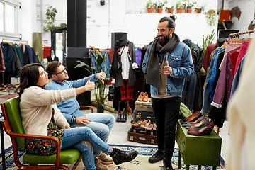 Image showing friends choosing clothes at vintage clothing store