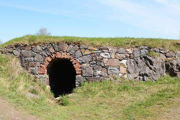 Image showing Dark tunnel entrance in a stone embankment 