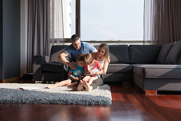 Image showing happy young couple spending time with kids